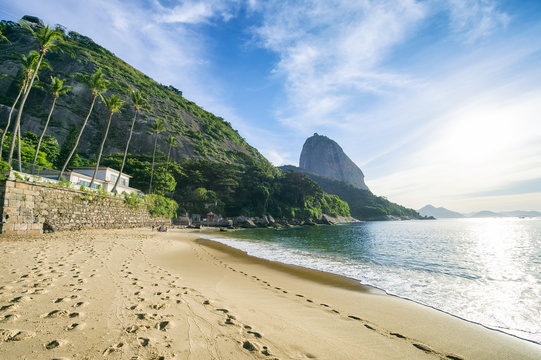 Sugarloaf Pão de Açucar Mountain standing above the quiet shore of Red Beach Praia Vermelha Rio de Janeiro Brazil
