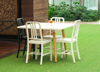 Fototapeta na wymiar Green garden and white table set