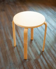 wooden chair on laminate flooring in the room