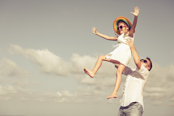 Father and daughter playing on the beach at the day time.