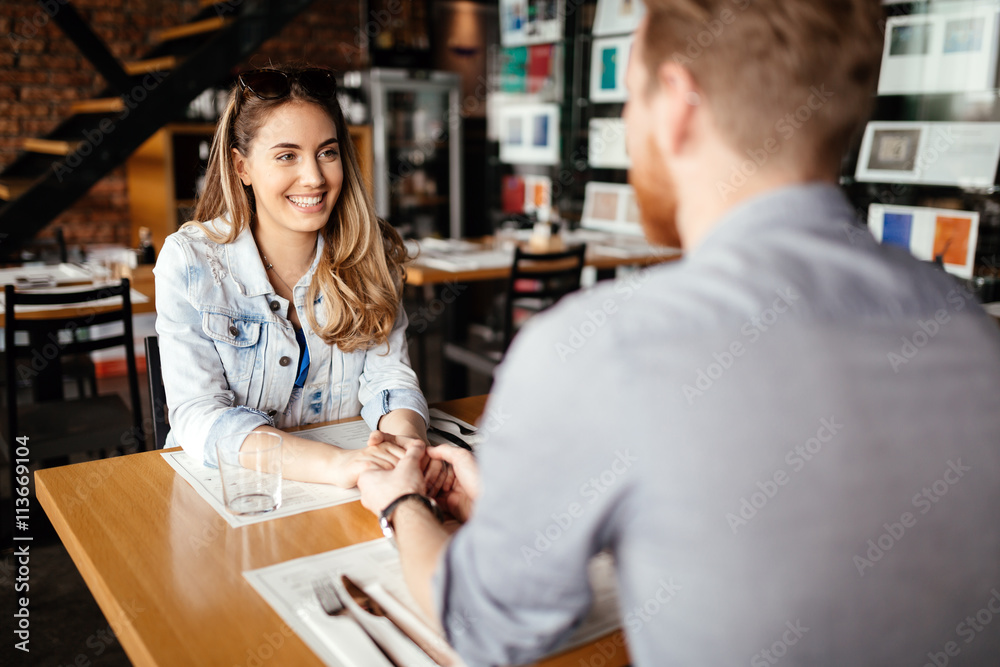 Poster couple dating in restaurant