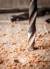 Detail of drill bit in a piece of wood