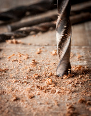 Detail of drill bit in a piece of wood