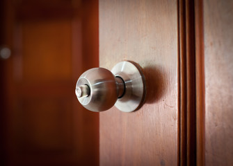 door handle keyhole with old design on brown wood door
