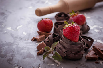 Uncooked chocolate pasta and strawberry