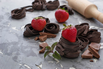 Uncooked chocolate pasta and strawberry