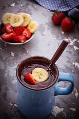 Chocolate fondue with strawberry and banana