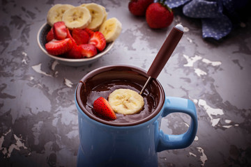 Chocolate fondue with strawberry and banana