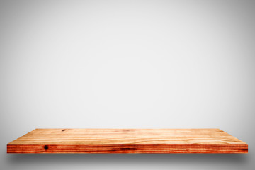 Empty wooden shelf on white wall background.