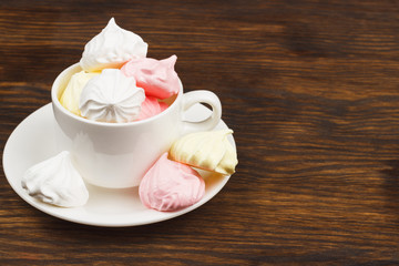 Cup with light pink meringues