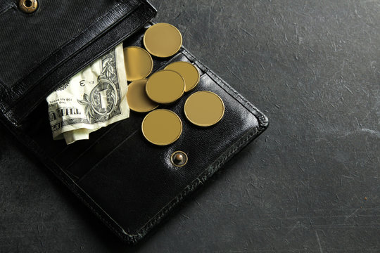 small money in my wallet on black background.The concept of poverty