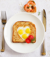 Toast with quail eggs. Snack on Valentine's Day.