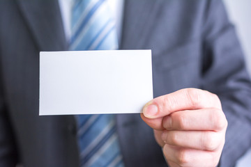 businessman holding white blank paper