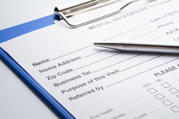 Patient information with pen and stethoscope white background