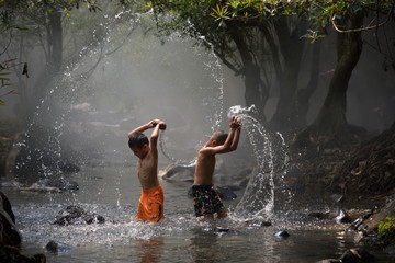 Child splashing played in pond