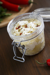 Preserved feta cheese in olive oil with chili and herbs
