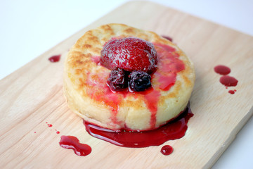 English Crumpets & Berry Topping on wood board isolate on white background
