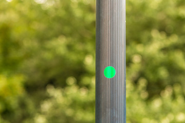 green circular sticker  on pole