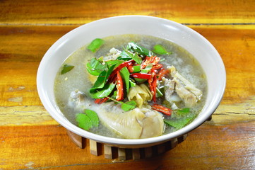 chicken leg Tom Yum Thai spicy soup on bowl