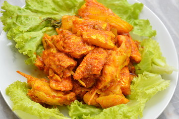 spicy stir fried salmon in curry paste on dish