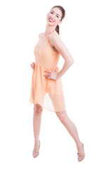 Fototapeta premium Attractive lady posing with shoulder in nude dress and heels