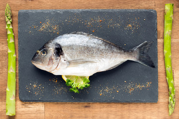 fresh raw dorado fish with spices on white background, top view, square image