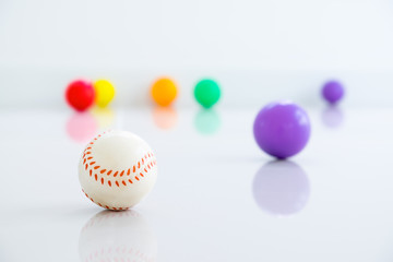 Baseball with colored balls on white background