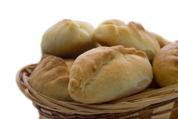 Traditional russian pies in the basket. Isolated on white.