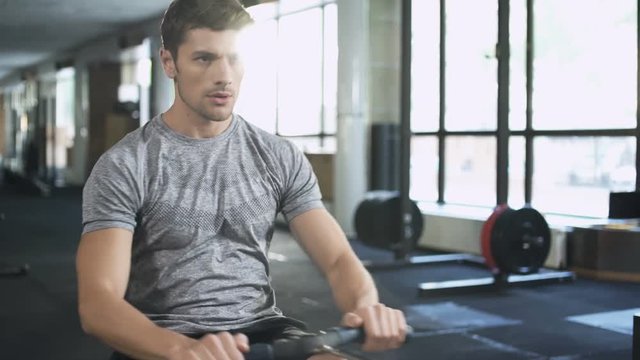 Man workout on fitness machine in gym