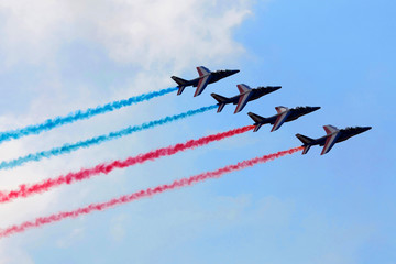 Aerobatic team in action on blue sky background
