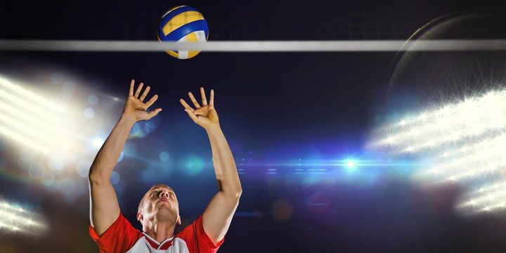 Composite image of sportsman throwing volleyball 