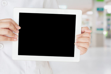 female doctor holding blank digital tablet with hospital interio