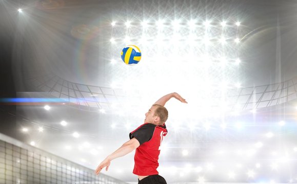 Composite image of sportsman hitting volleyball