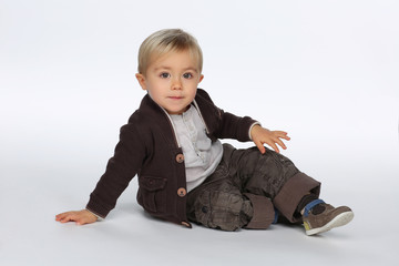 Handsome kid in brown outfit playing