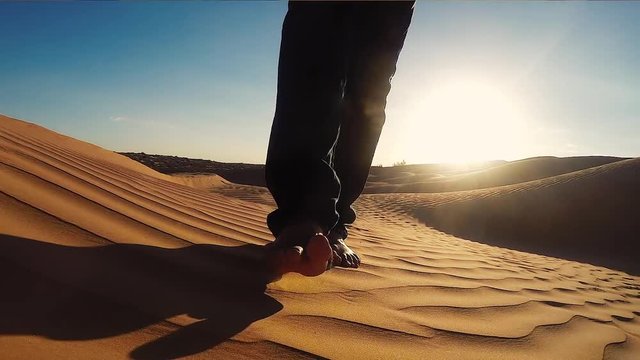 Man Walking on a Sahara Desert Dune close up