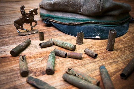 Old cartridge shells, various coins and military cap