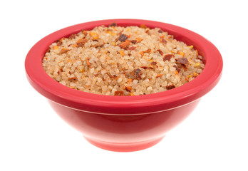 Small dish filled with salt, red chili pepper and paprika side view isolated on a white background.
