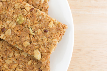 Cinnamon sesame and pumpkin seed granola bars on a plate top close view.