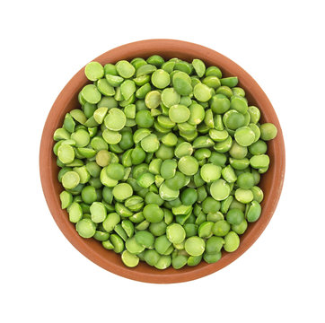 Portion of organic green split peas in a small bowl top view isolated on a white background.