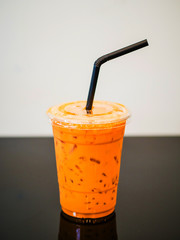 Iced Milk Tea with straw in plastic cup