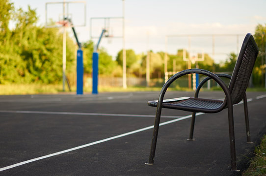 Bench near backetball court.