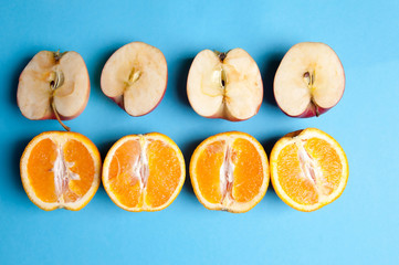 Oranges and apples on blue background