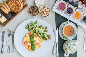 Absolutely Amazing Top View of Bread, Tea, Tasty Berry Jam, Scrambled Eggs with Salad on the Table for Breakfast, Brunch Time in Restaurant, Breakfast Conception