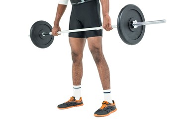Fototapeta na wymiar Mid-section of bodybuilder lifting heavy barbell weights