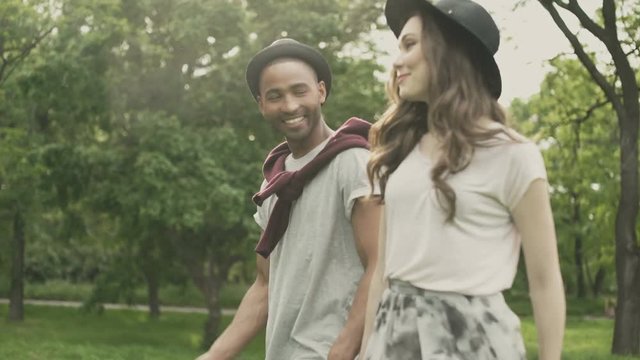 Young beautiful couple walking in the park
