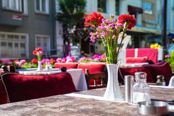 Fototapeta na wymiar Outdoor summer cafe tables with beautiful flower,europe restaura