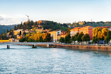 Facades of old houses on waterfront of the Adige River in Verona