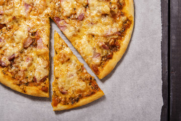 Pizza with bacon, cut into pieces 