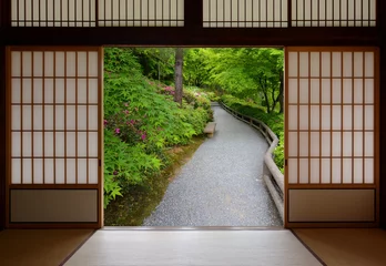  Japanese sliding wood doors opened to a peaceful green nature path © David Carillet