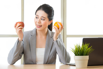 Young asian businesswoman eating healthy snack